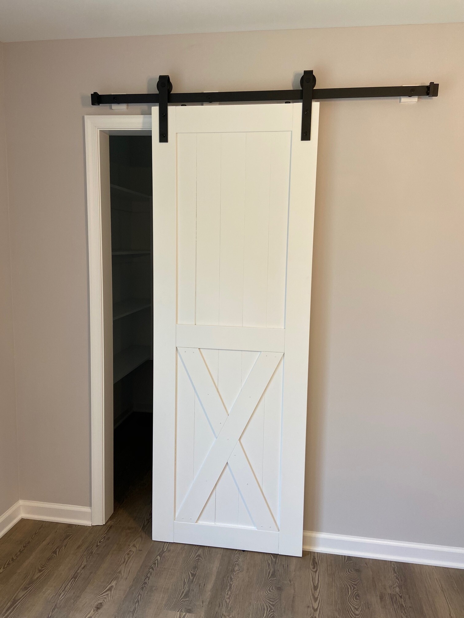 Barn door closet entry by Seely Homes, Delaware