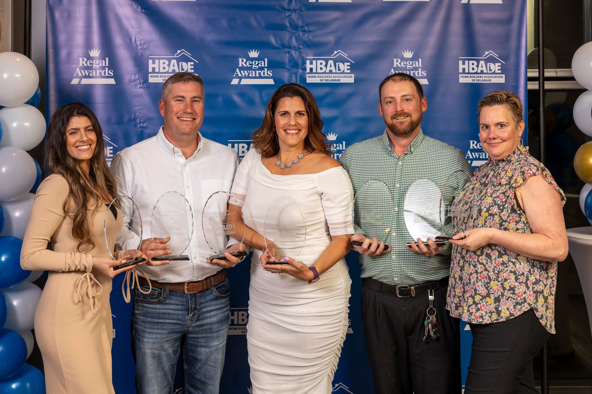 Photo shows the Team at Seely Homes who earned 7 Regal Awards from Delaware Association of Home Builders. Pictured L to R: Cassie Davis, Adrian Seely, Julleanna Seely, Nathaniel Maynard, and Colleen Watson